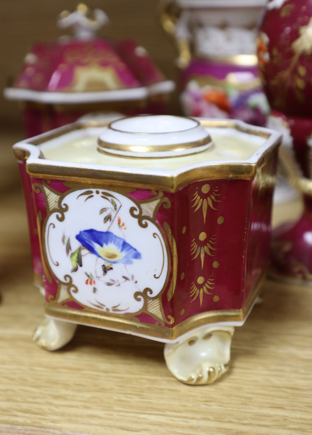 A group of English porcelain ruby ground vessels, c. 1825-45,